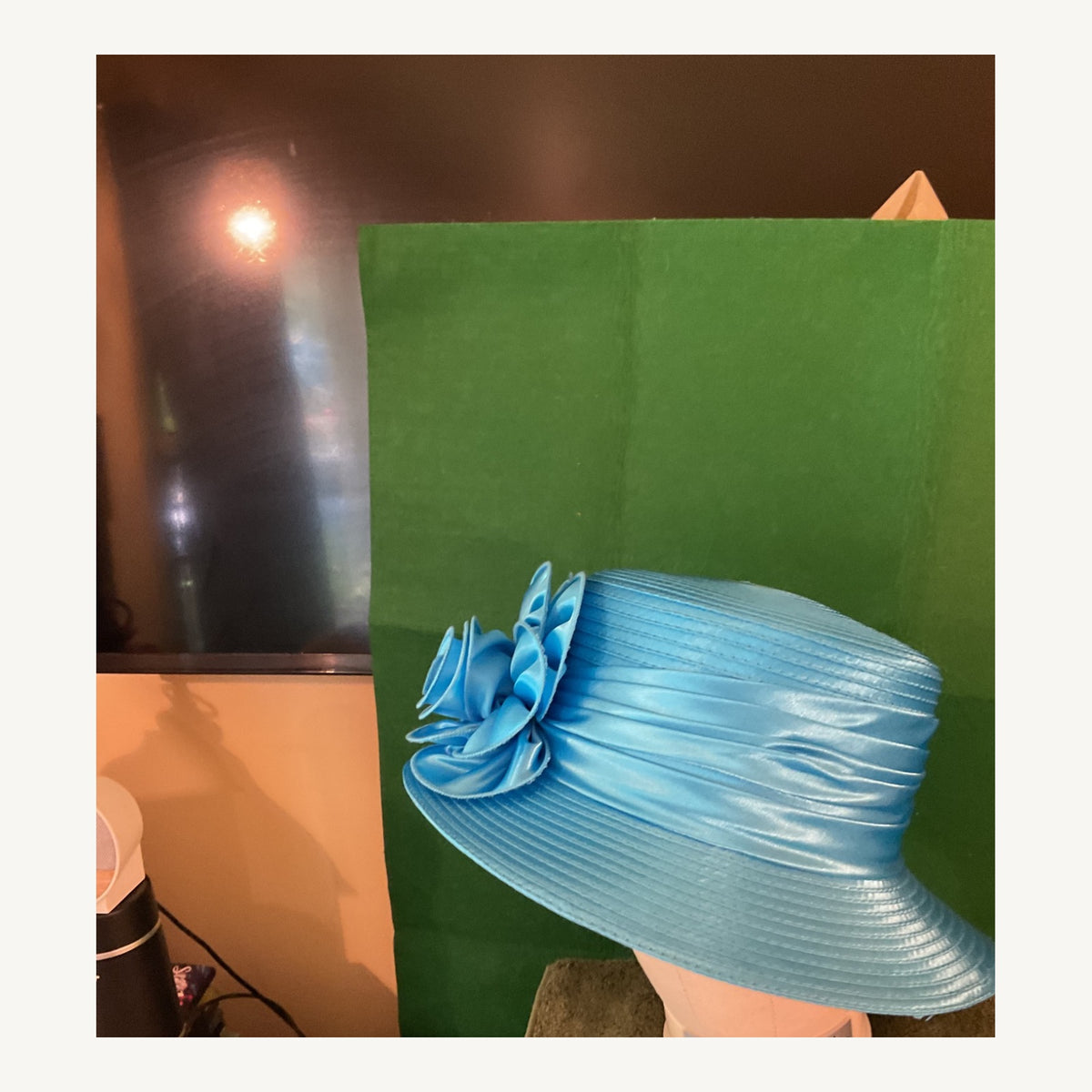 Sapphire blue satin-look occasion hat with large sculptural floral detail, pre-owned.