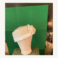 Ivory pleated turban-style occasion hat with large rose detail, pre-owned.
