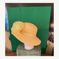 Yellow wide-brim occasion hat with pearl accents and large organza flower, pre-owned.