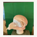 Blush satin-look cloche-style occasion hat with oversized bow and small crystal accents, pre-owned.